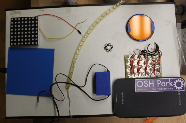 upper left, 8x8 panel.  lower left, EL panel.  Middle, 24 led car strip, 1W LED, inverter.  Right top, lens filter.  Right middle 3x5 LED panel, lower right cell pone.